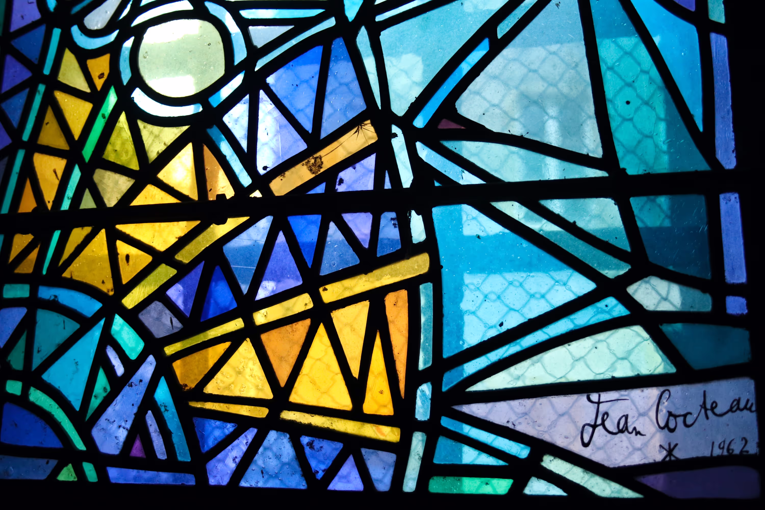 Stained glass window by Jean Cocteau, abstract, vibrant, 1962.