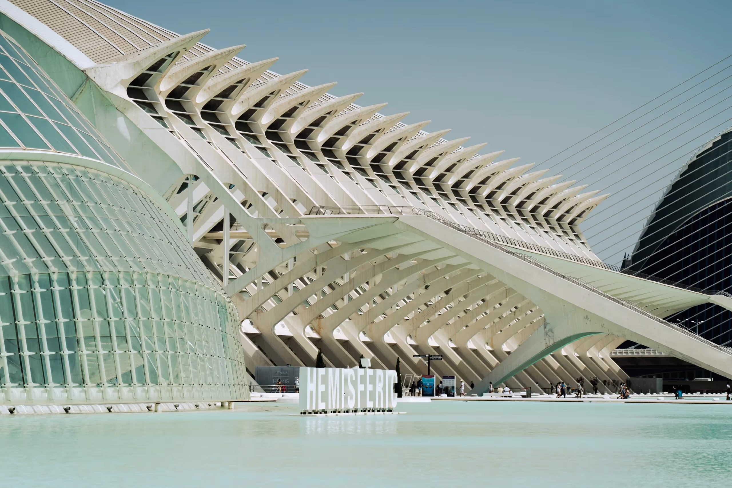 Modern architecture, geometric forms, concrete, glass, serene, futuristic.