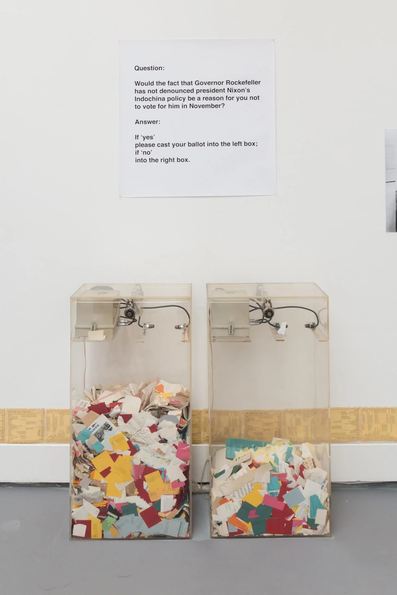 Interactive art installation with voting boxes and political question.